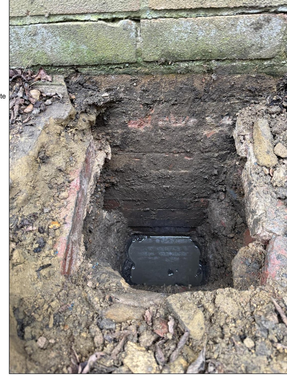 Site photograph of an exposed existing garage footing in a trial pit